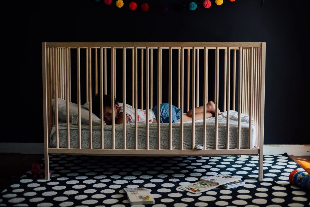 Baby inside a Wooden Crib