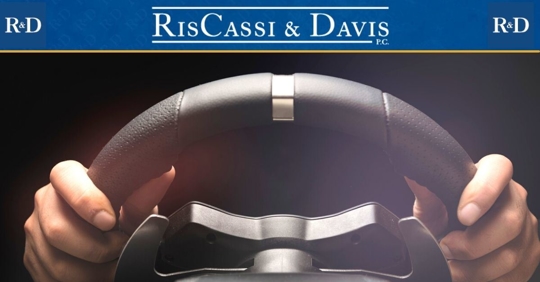 Isolated hands holding steering wheel