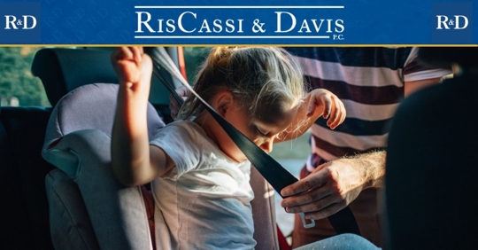 Child getting buckled into a car seat