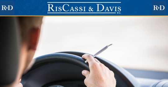 Man driving with a marijuana joint in his hand