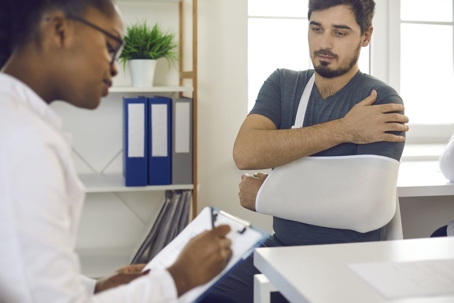 Man with injured shoulder at a doctor's office