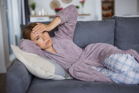 woman lying on sofa at home