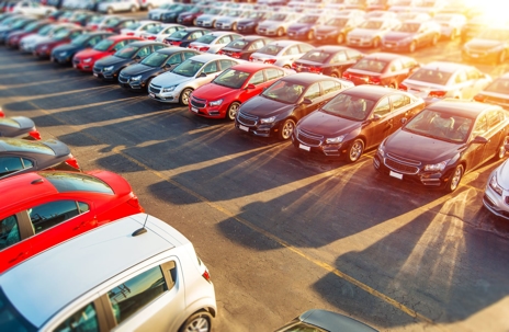 rows of cars at a car dealership