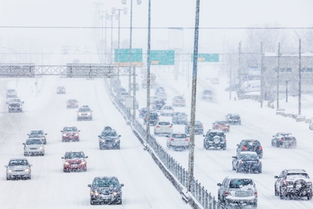 Cars keeping safe while driving through a snowstorm