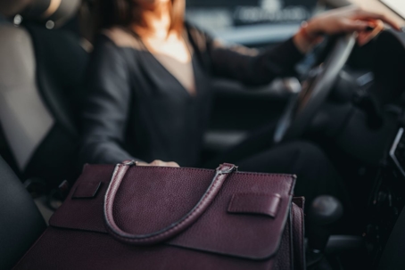 Woman reaching into purse while driving