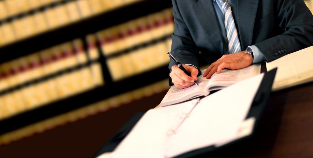 Man in a Suit Writing on a Document