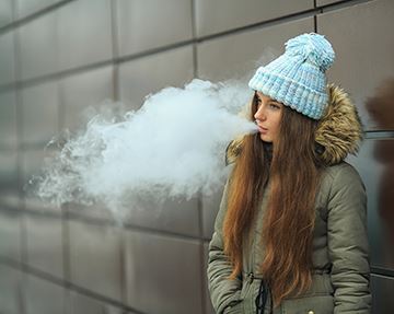 Lady Vaping Outdoors