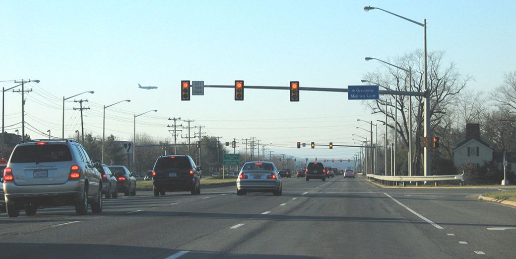 cars waiting at a stop light