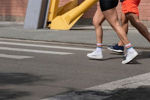 joggers running across the road