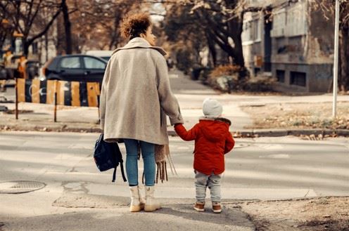 mother and child waiting to cross street