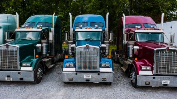 semi trucks parked on the side of the road